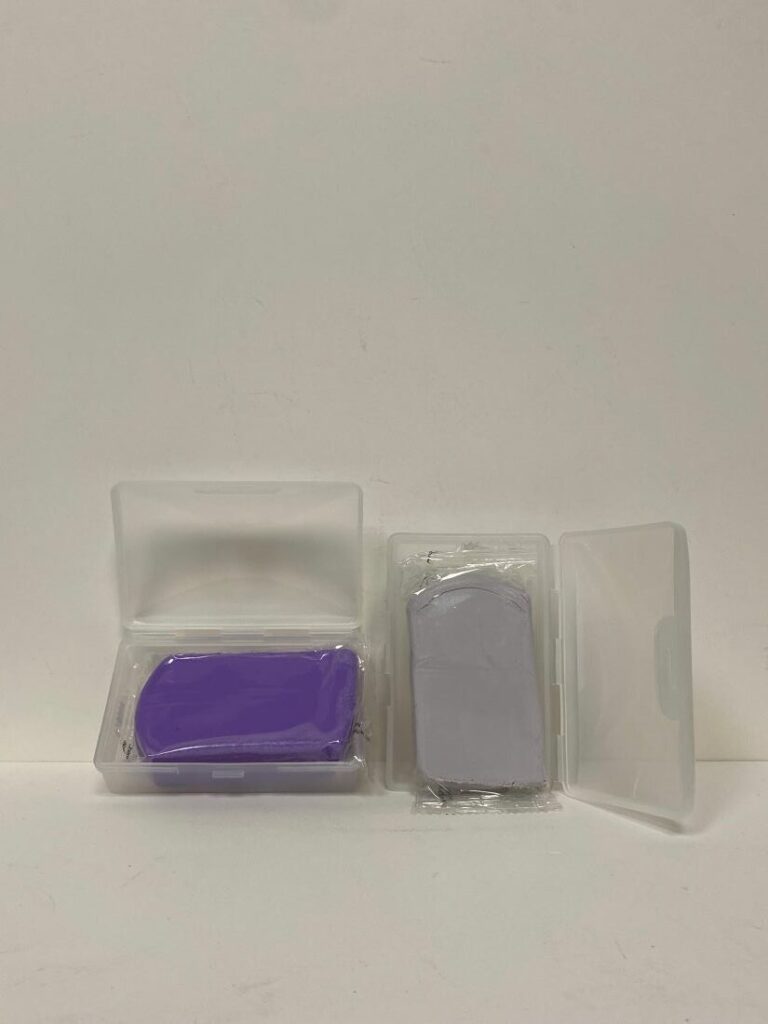 Two small rectangular objects in transparent cases, one purple and one gray.