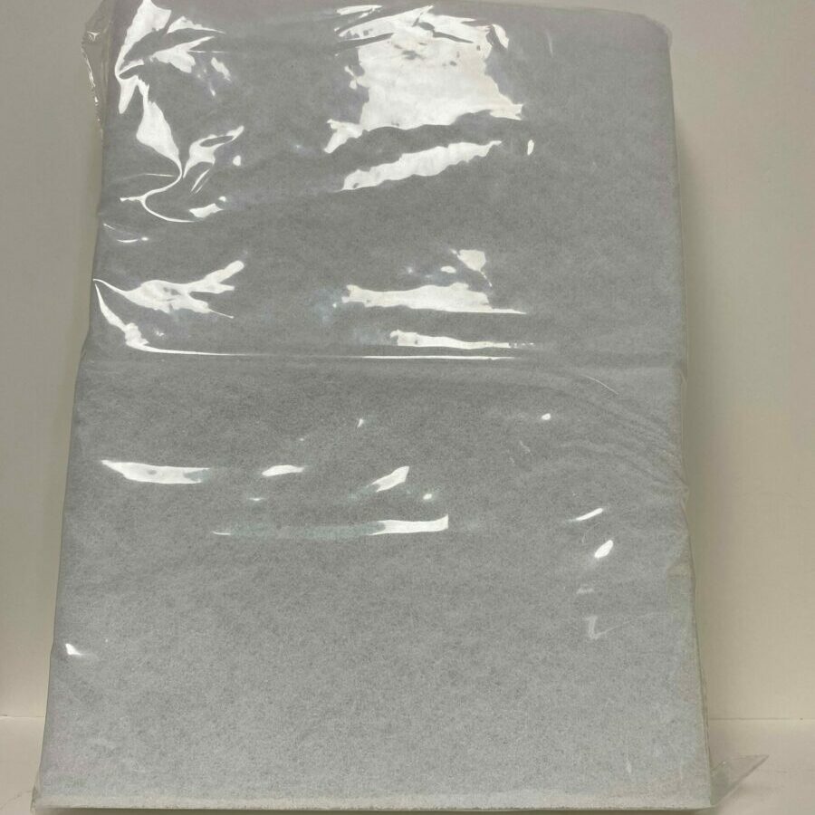 A clear plastic bag containing a folded white fabric or paper sheet.