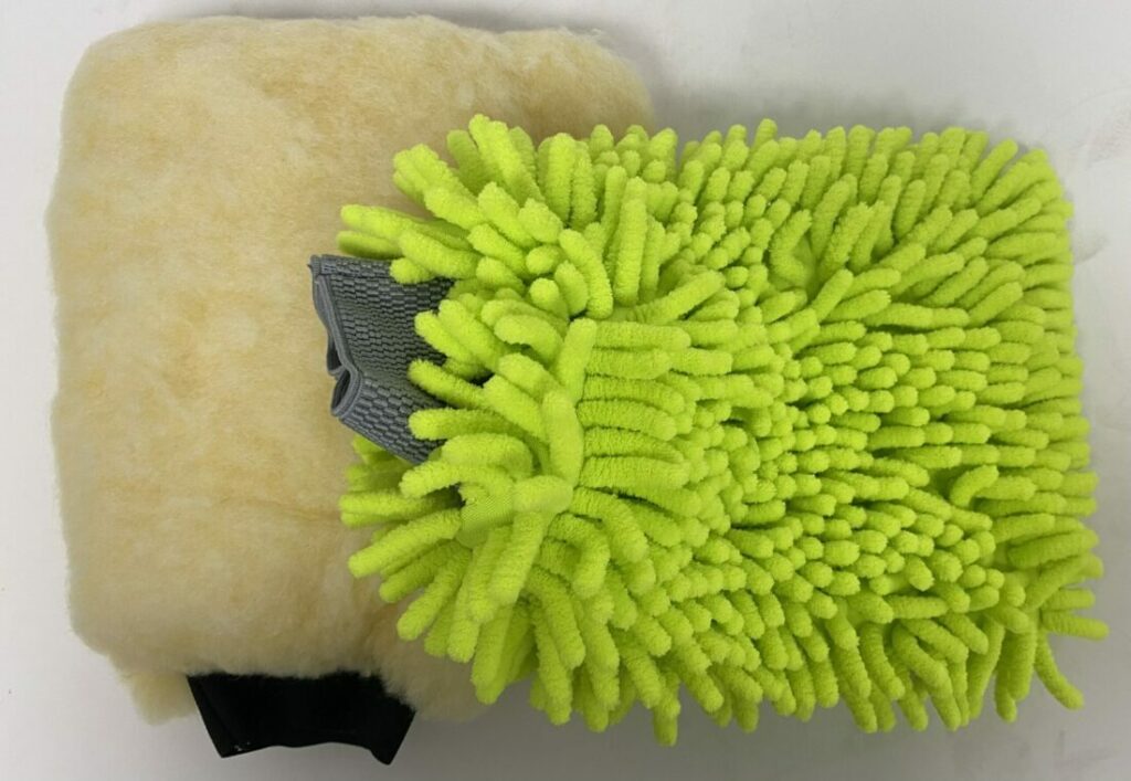 A green microfiber cleaning mitt with a gray thumb section.