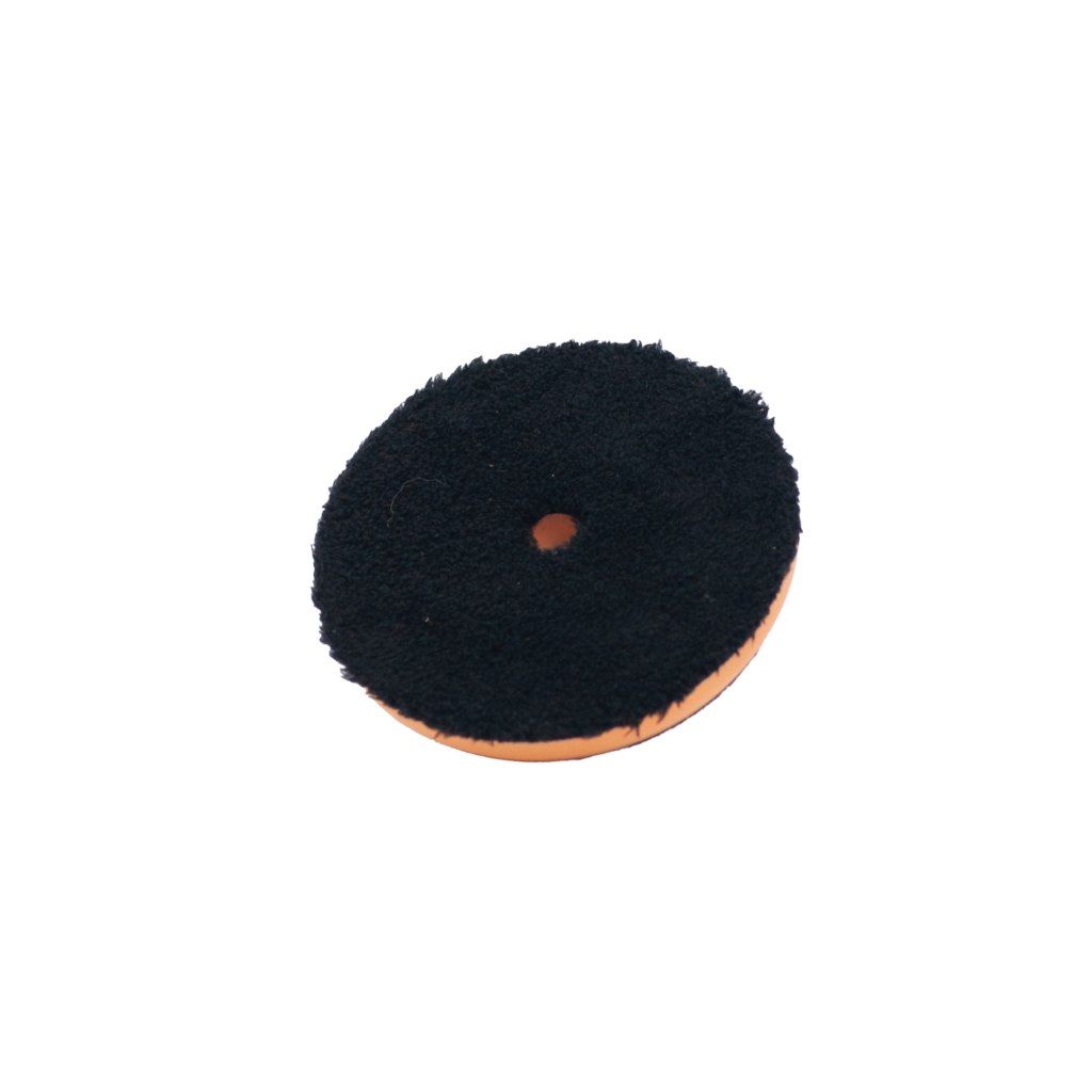 Black and orange circular felt pad with central hole.