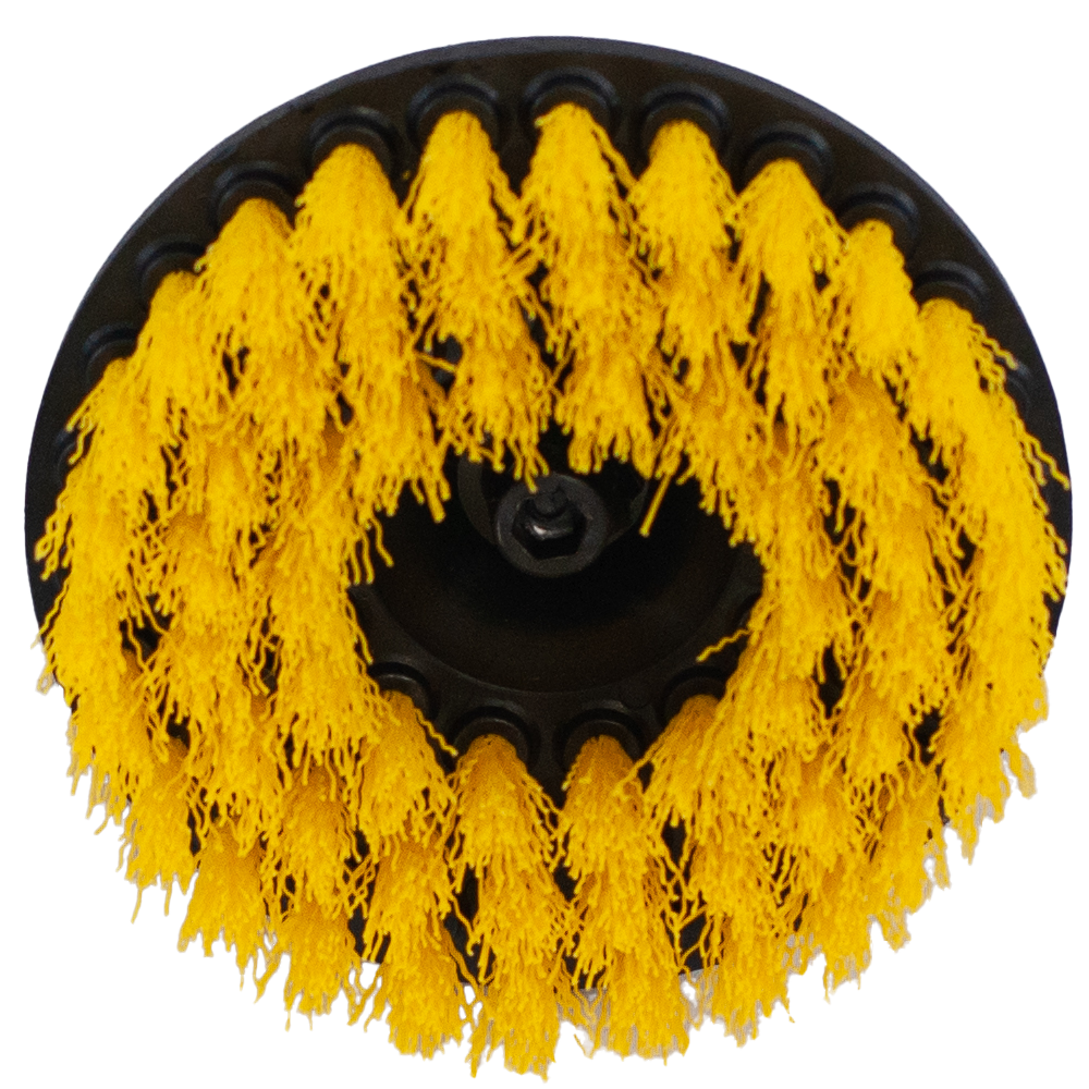 Top view of a circular brush with yellow bristles.