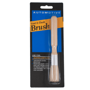 A packaged automotive vent and dash brush with a beige handle.