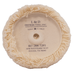 A round, fluffy beige cleaning pad with company branding in the center.