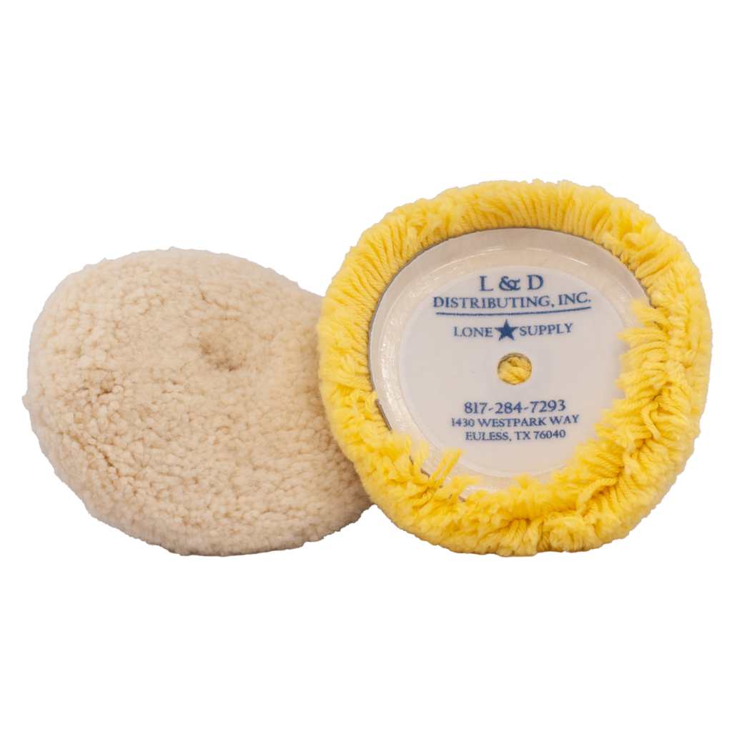Two round buffing pads, one beige and one yellow with label.