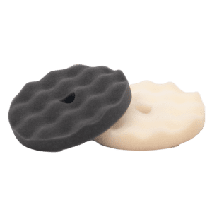 Two textured polishing pads, one black and one white, with wavy surfaces.