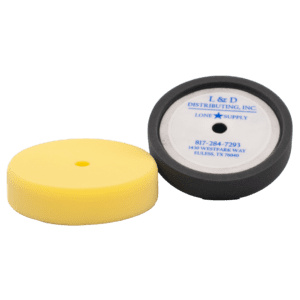 Two polishing pads, one yellow and one black with a label.