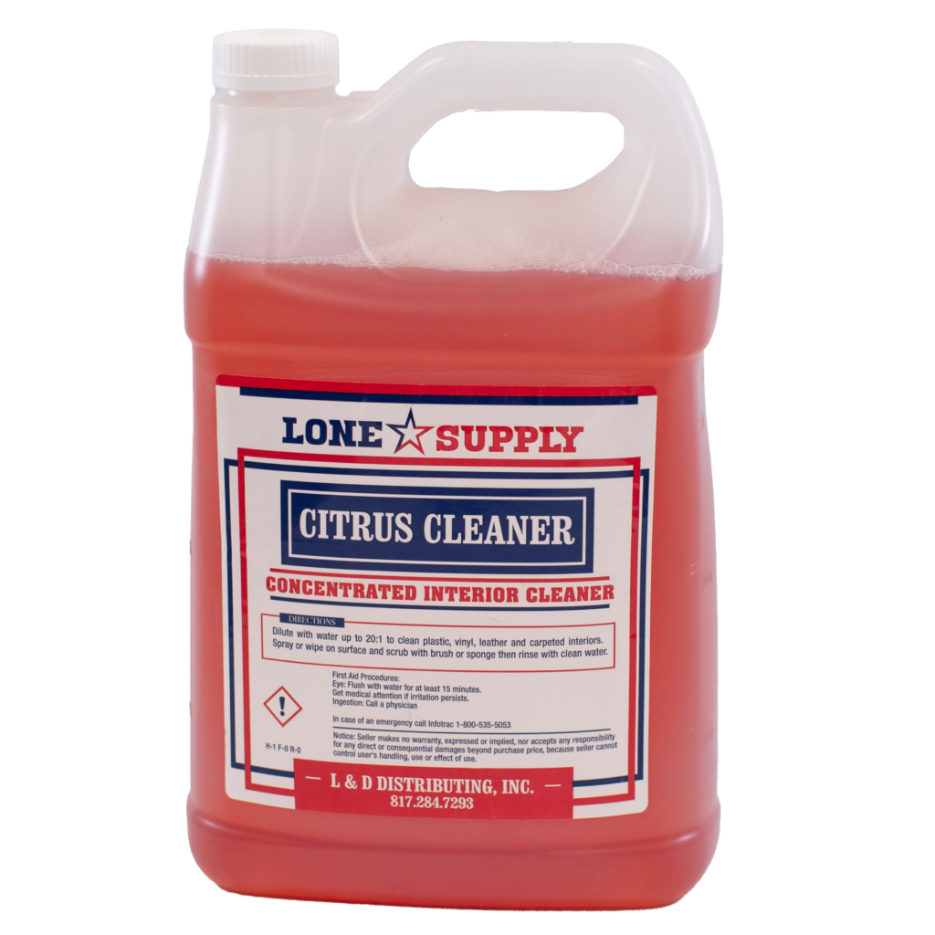 A gallon jug of Lone Star Supply citrus cleaner with red liquid inside.