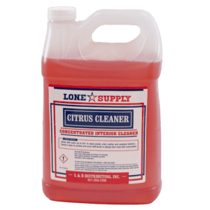 A gallon jug of Lone Star Supply citrus cleaner with red liquid inside.